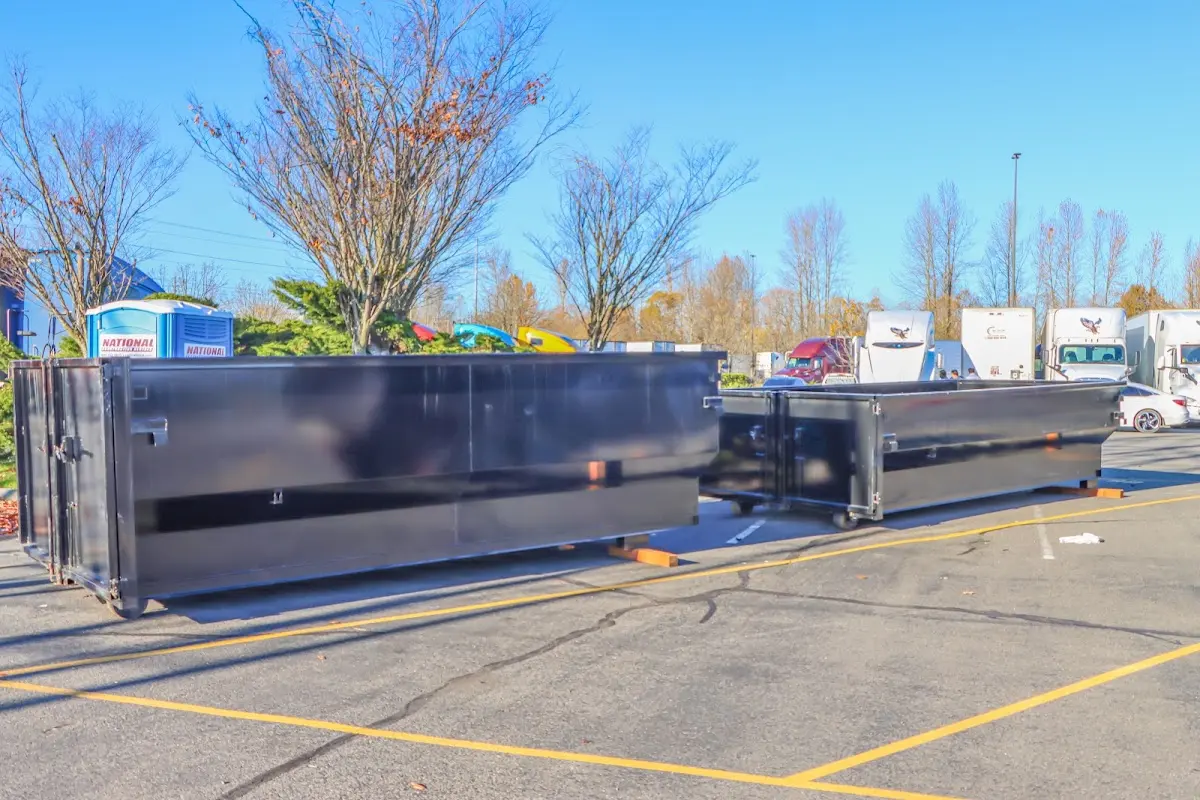 Professional dumpster rental service with roll-off container on residential driveway in Fairlawn